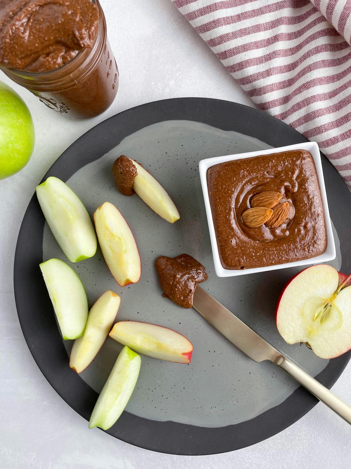 Chocolate almond butter by some sliced apples.