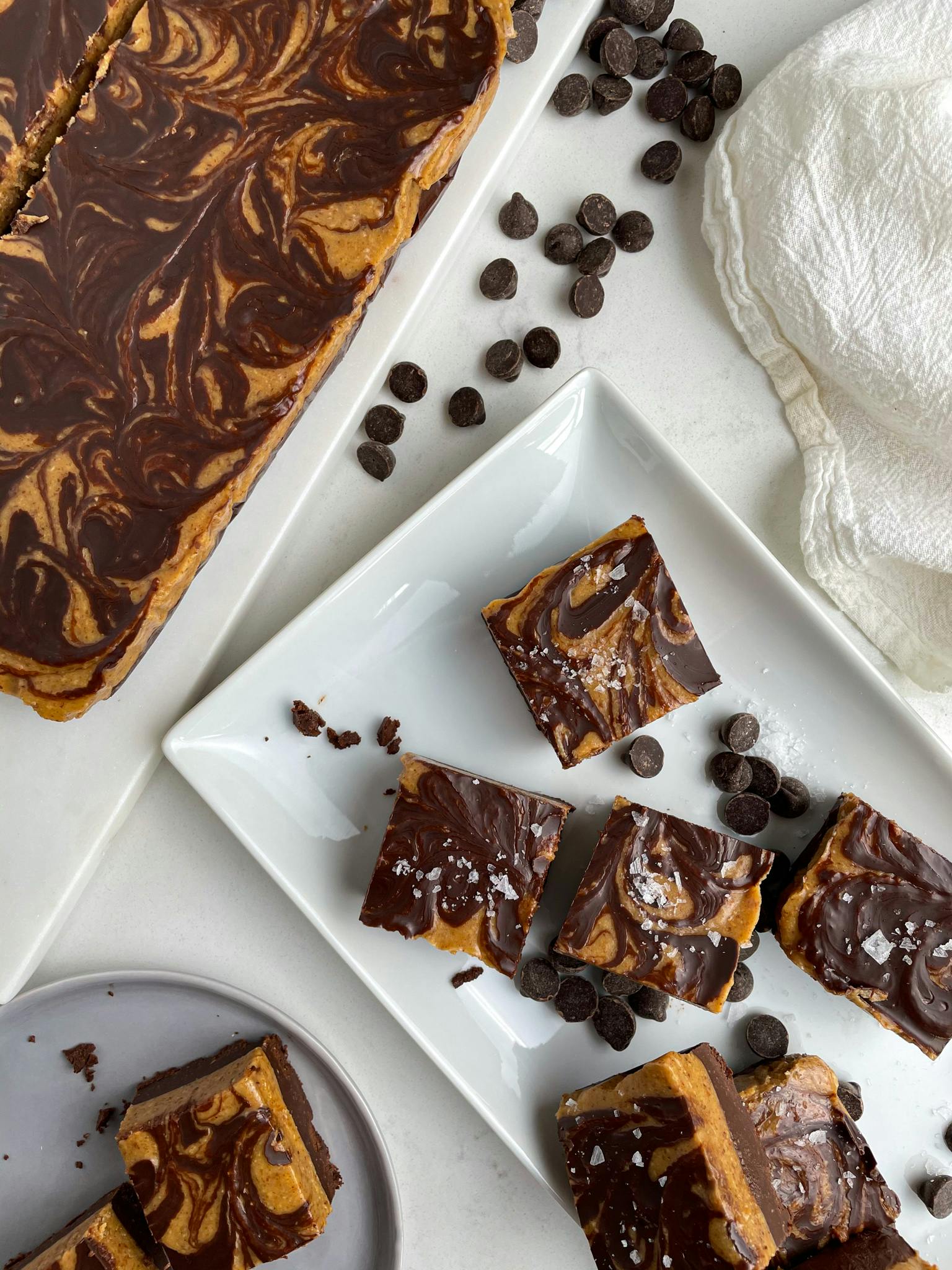 Pieces of almond butter fudge on a white plate.